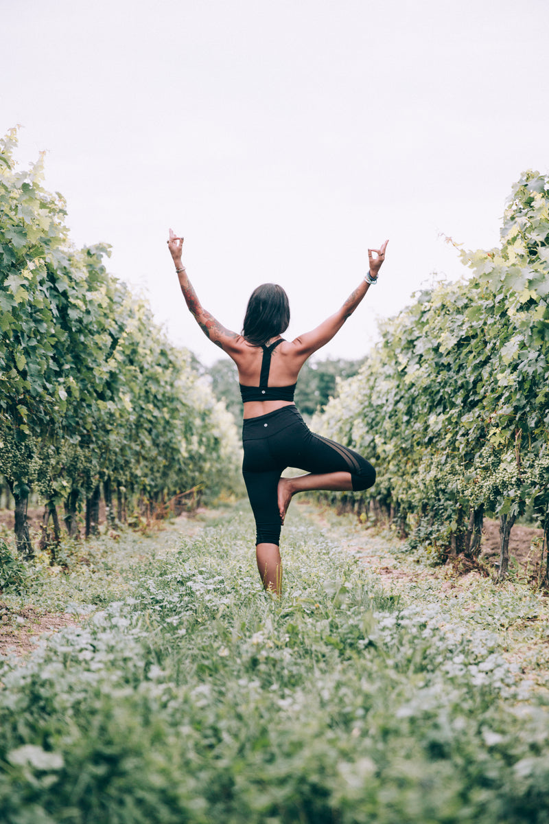 tree yoga pose in California vineyard healthy lifestyle balance